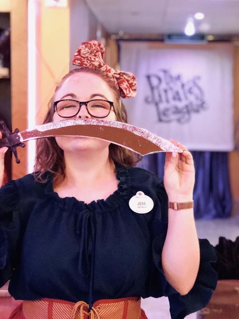 Disney cast member dressed as a pirate in Pirate's League with pirate sword