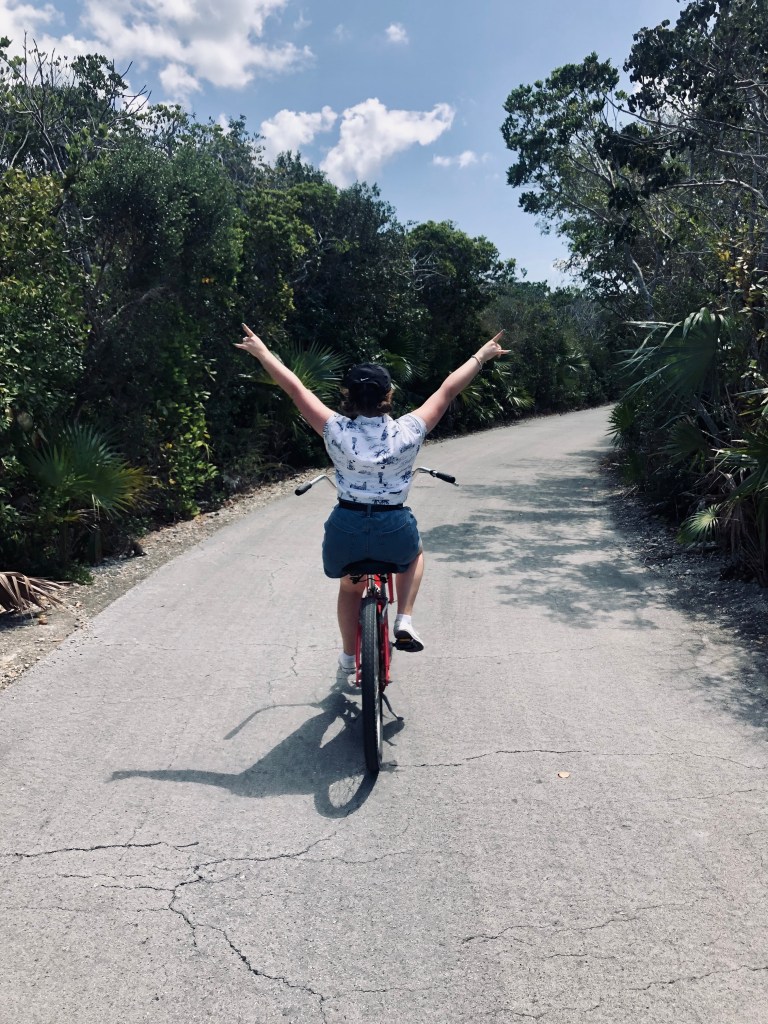 Girl riding bike on road on Castaway Cay