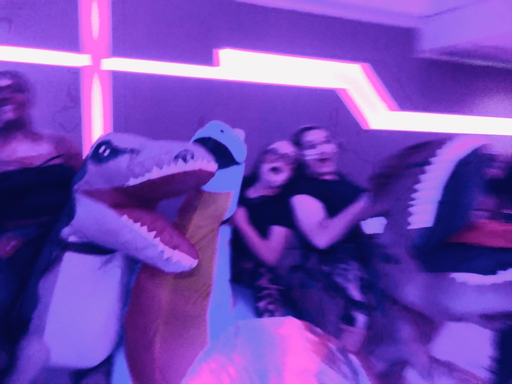 Inflatable dinosaur costumes at a Crew Halloween Party on a disney cruise