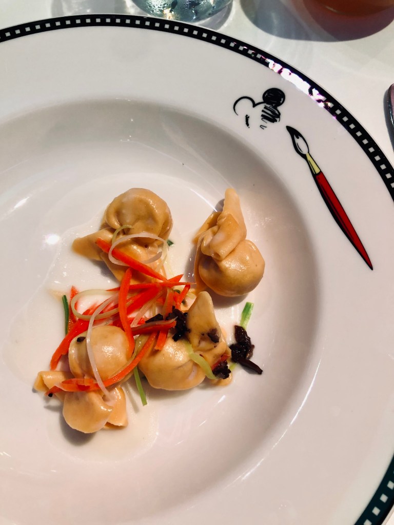 Black truffle pasta on an animators palate plate onboard a disney cruise ship