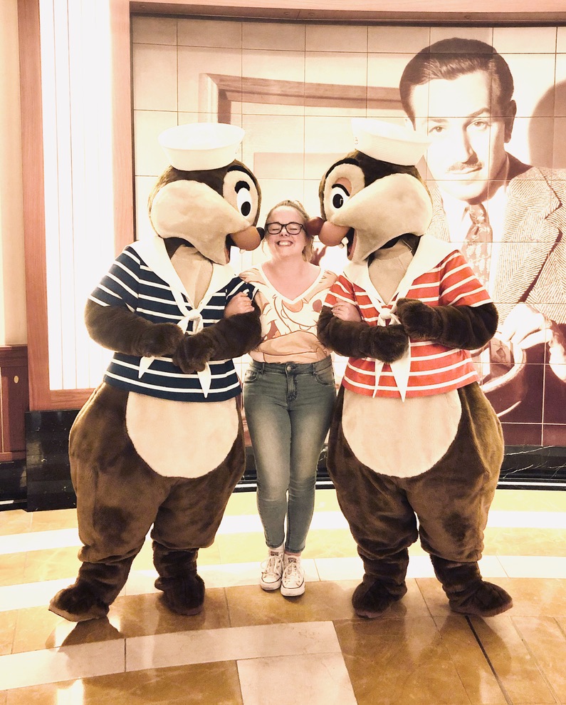 Girl getting kisses from Chip and Dale on Disney Cruise Ship