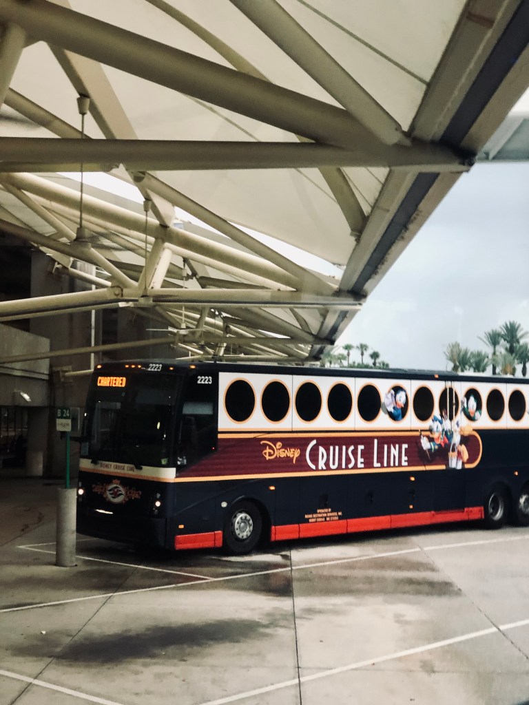 Disney Cruise Line bus parked at airport.