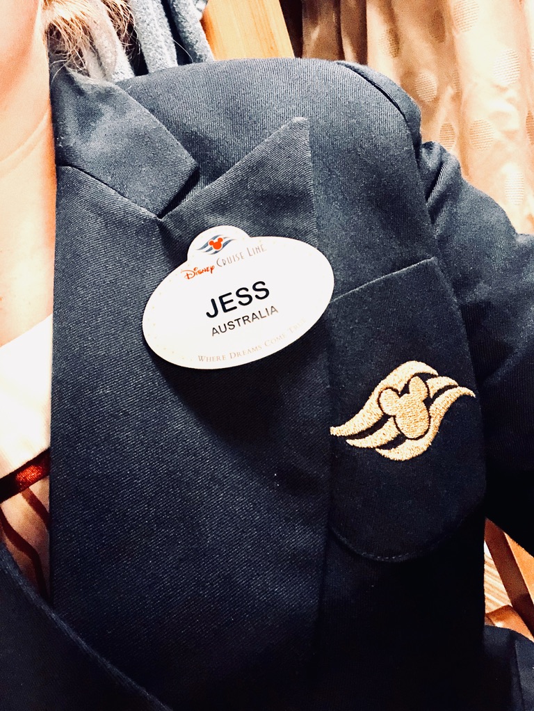 Disney Cruise Line Cast Member taking selfie of Disney Name Tag in merchandise costume.