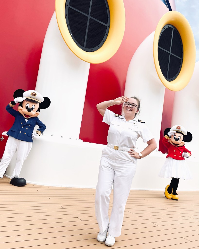 Disney Cruise Line Funnel with ship officer smiling next to Mickey Mouse and Minnie Mouse in captain outfits.