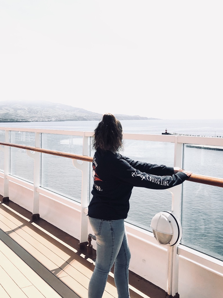 Girl in disney cruise line sweater looking out at ocean