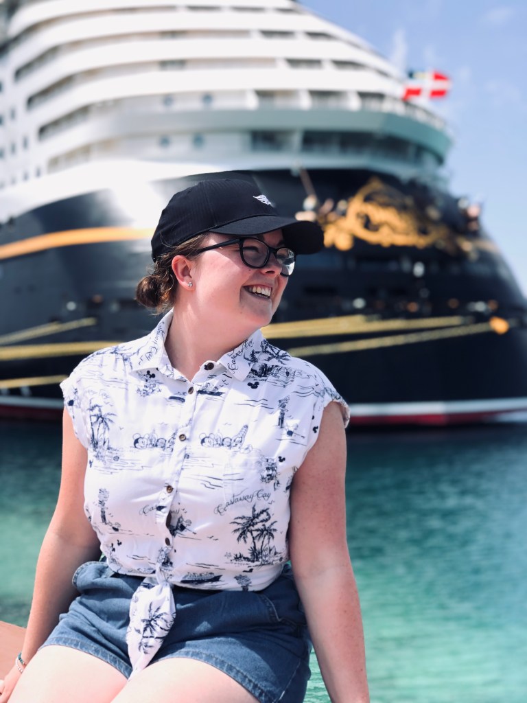 Girl smiling infront of Disney Dream cruise ship.