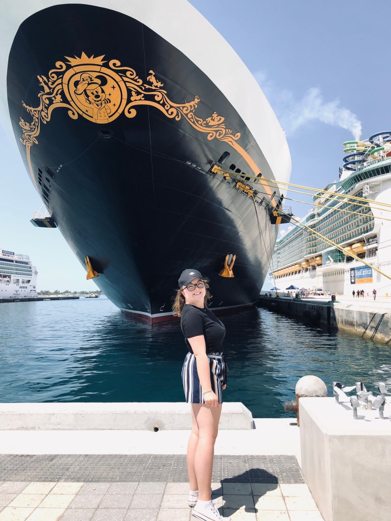 Girl standing in front of bow of Disney Dream Cruise ship.