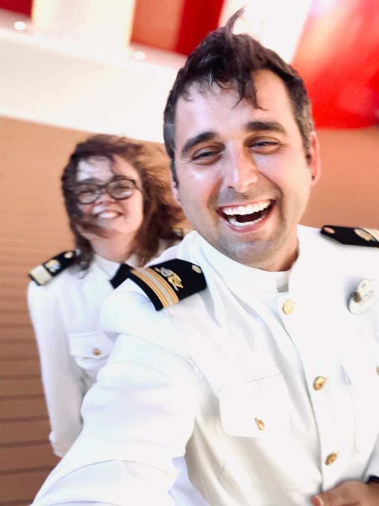 Disney Cruise Line officers taking selfie laughing on deck.