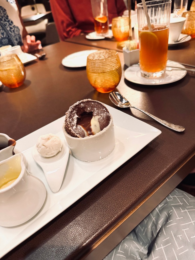 Chocolate Souffle on table with chocolate sauce and ice cream at Palo restaurant on a Disney Cruise Ship