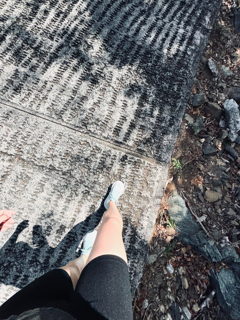 Legs walking on road leading up to Paradise Point at St Thomas.