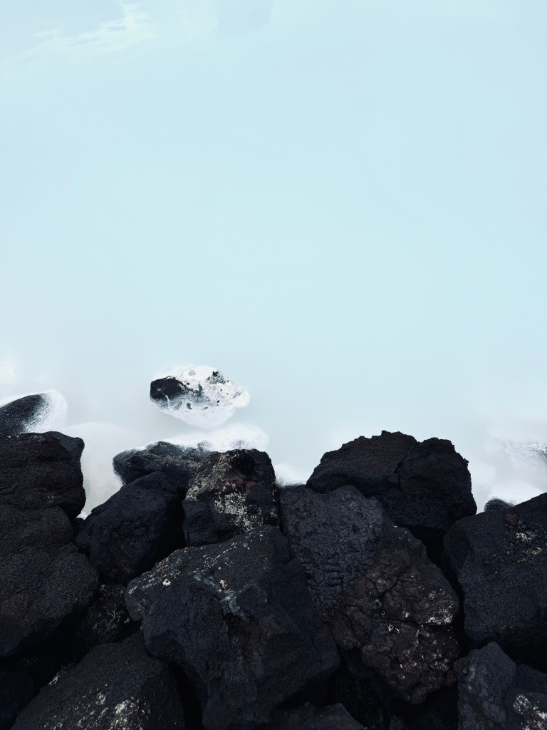 Milky blue water pools with steam at Blue Lagoon, Iceland