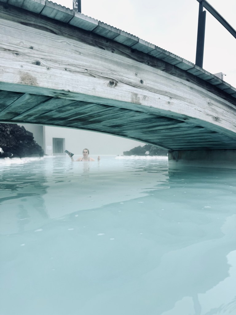 Bridge over blue water pools with steam at Blue Lagoon, Iceland