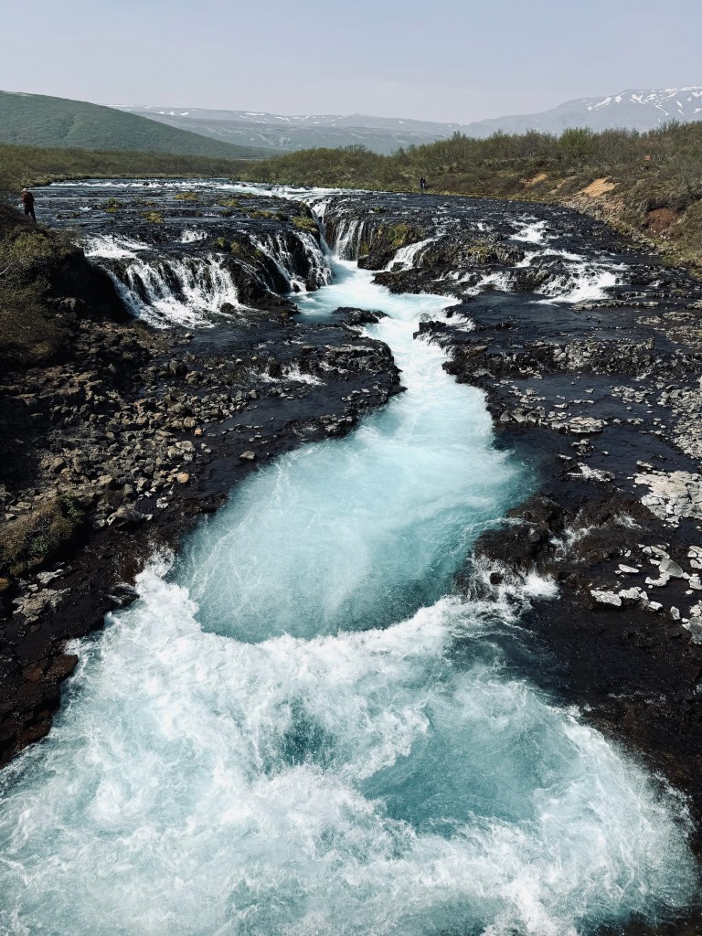 Aqua blue waters of Bruarfoss waterfall in Iceland