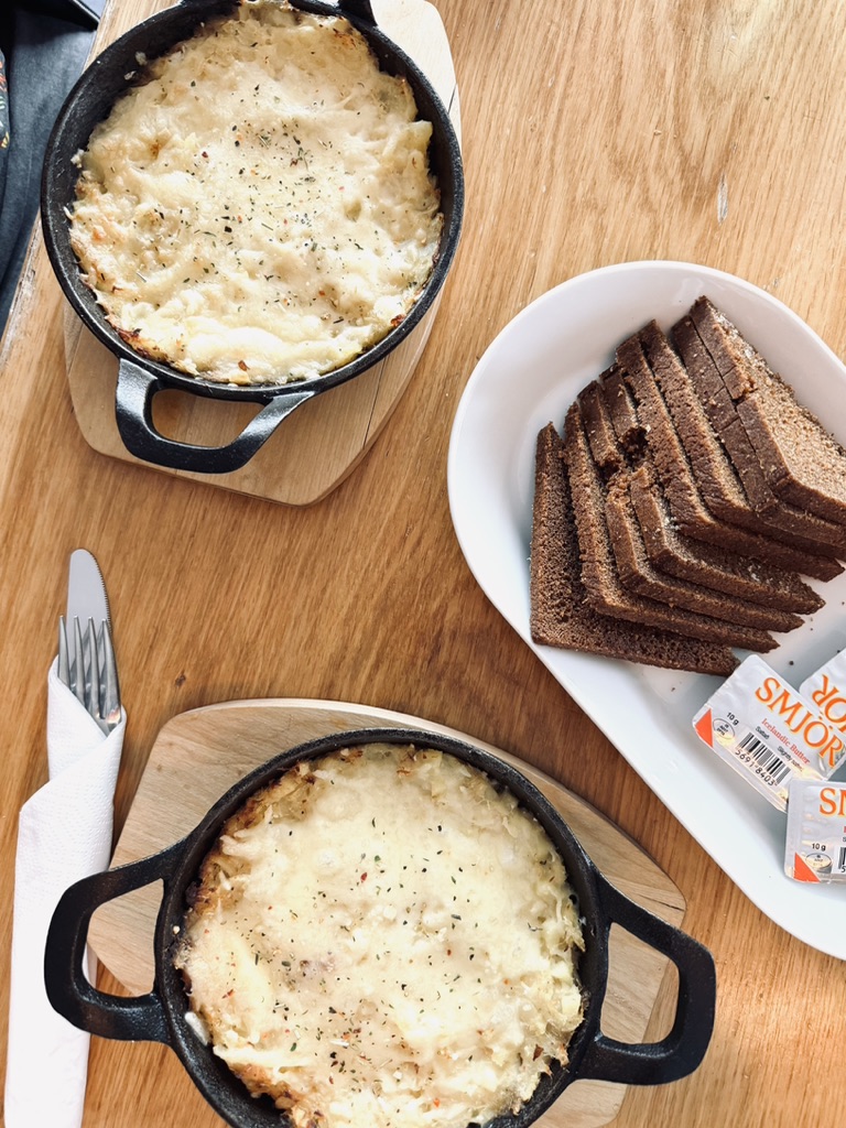 Fish Stew and Icelandic bread in a stylish black dish on a wooden table