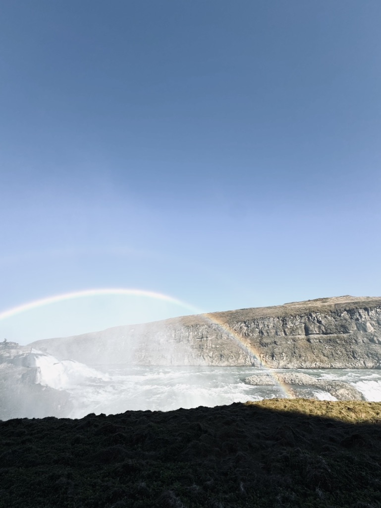Rainbow over Gullfoss Waterfall on a sunny day in Iceland