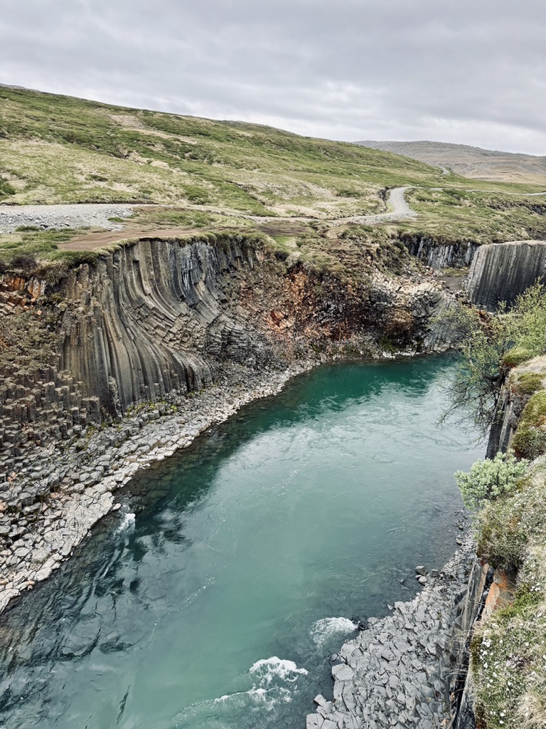 Rock formations and canyon with blue water at Studlagil Canyon, Iceland
