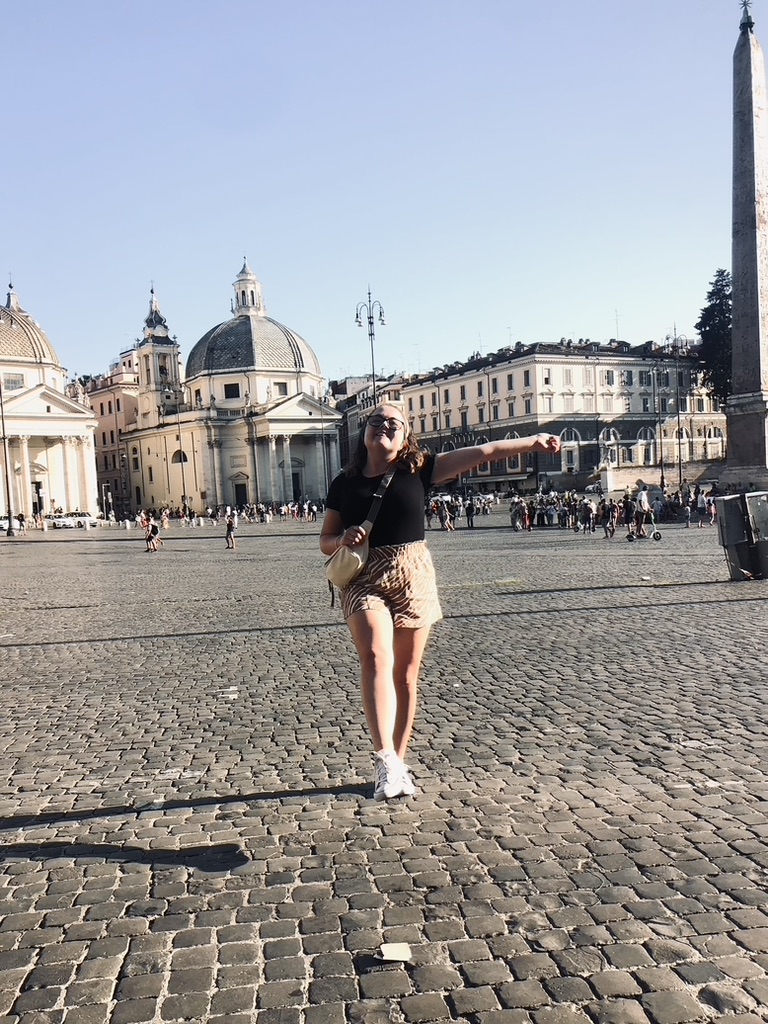 Girl dancing in Piazza del Popolo square in Rome, Italy