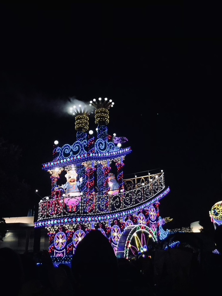 Tokyo Disneyland Electrical Parade float with Daisy Duck at night.