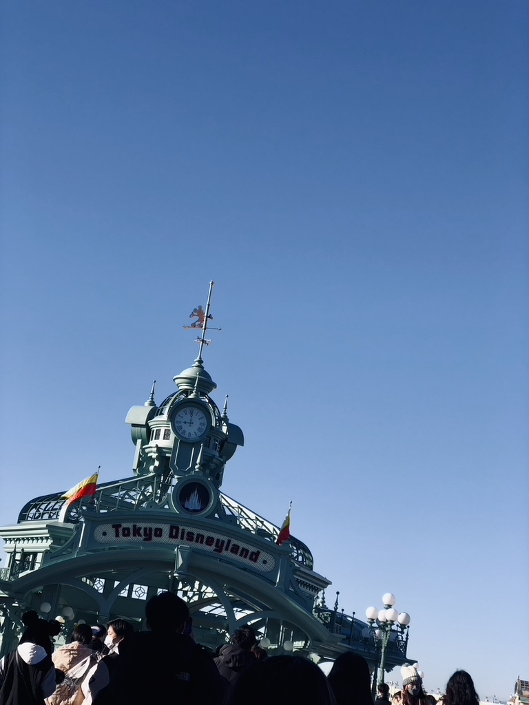 Tokyo Disneyland entrance with clear blue skies.