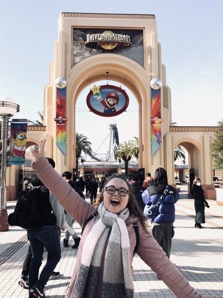Universal Studios Japan entrance with girl smiling.