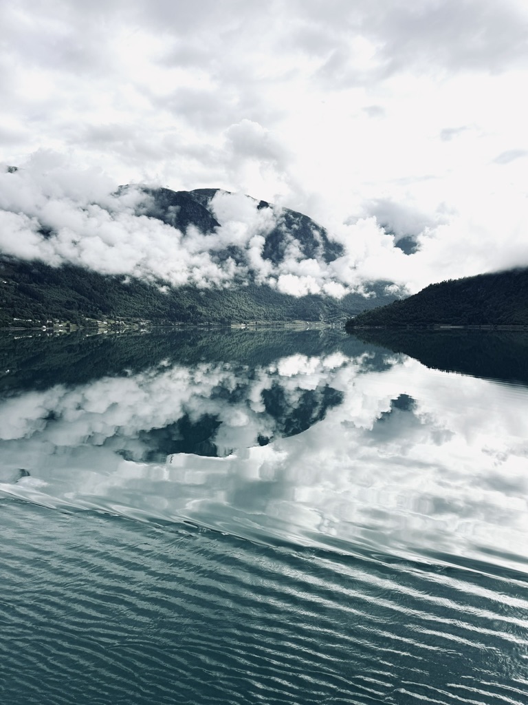 Mirror reflection of Norwegian Fjords from a cruise ship
