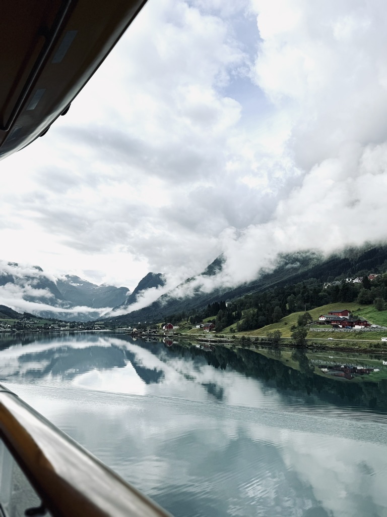 View of Norwegian fjords with clouds on mountains from a disney cruise ship