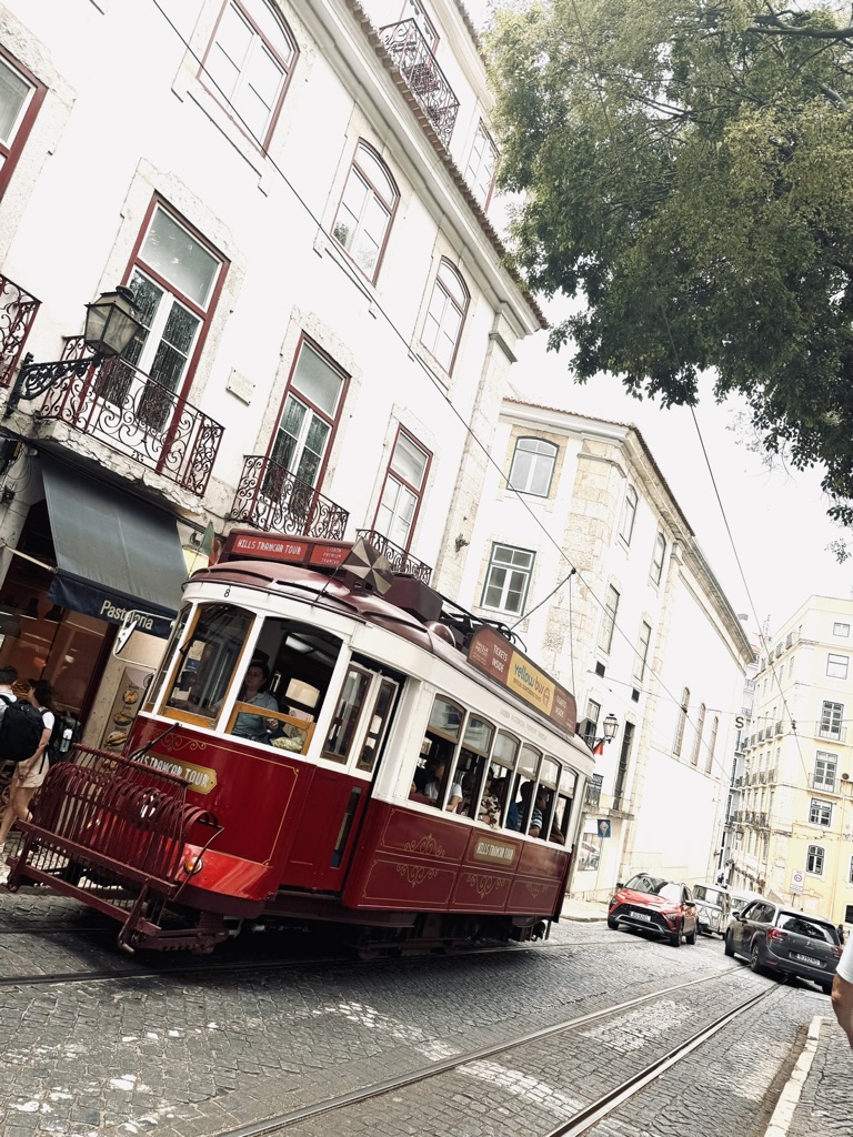 Red tram on a street in Lisbon, Portugal