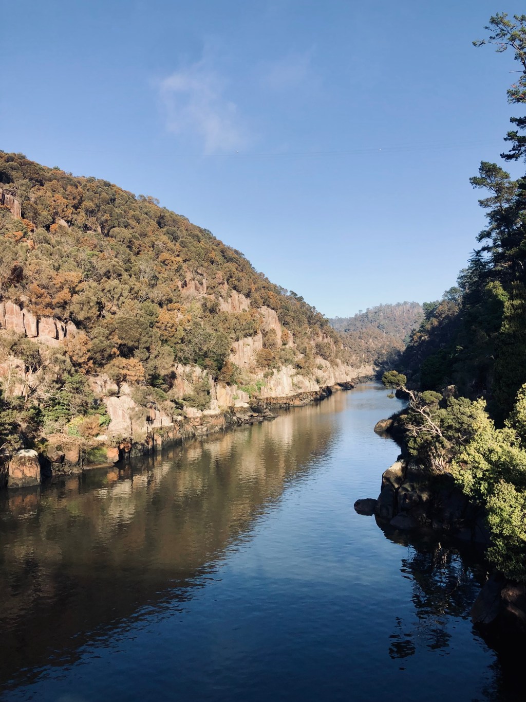Reflection of hills on water in Cateract Gorge in Launceston, Tasmania