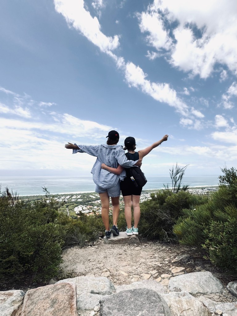 Two friends looking at the view of the ocean from the top of Mt Coolum National Park, Sunshine Coast