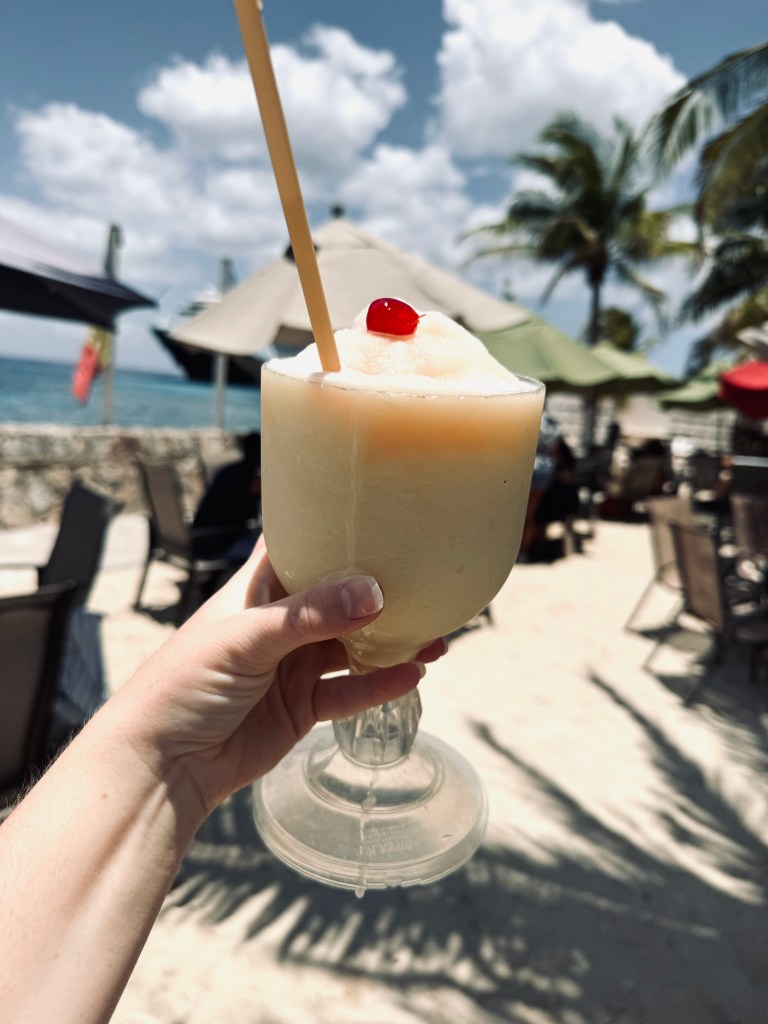Hand holding frozen margarita at No Name Bar in Cozumel, Mexico