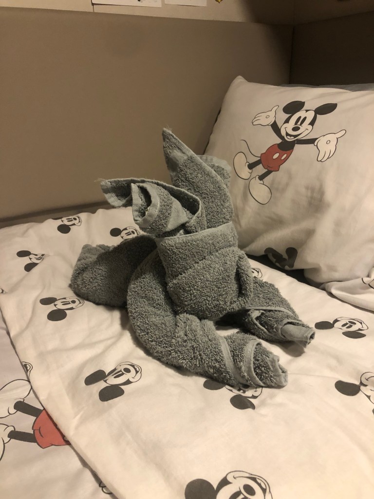 Towel animal on bed in a crew member cabin on a disney cruise ship