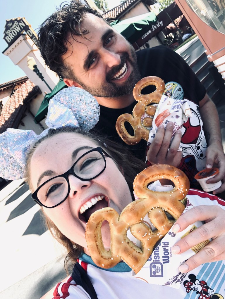 Friends taking selfie with mickey pretzel at Hollywood Studios
