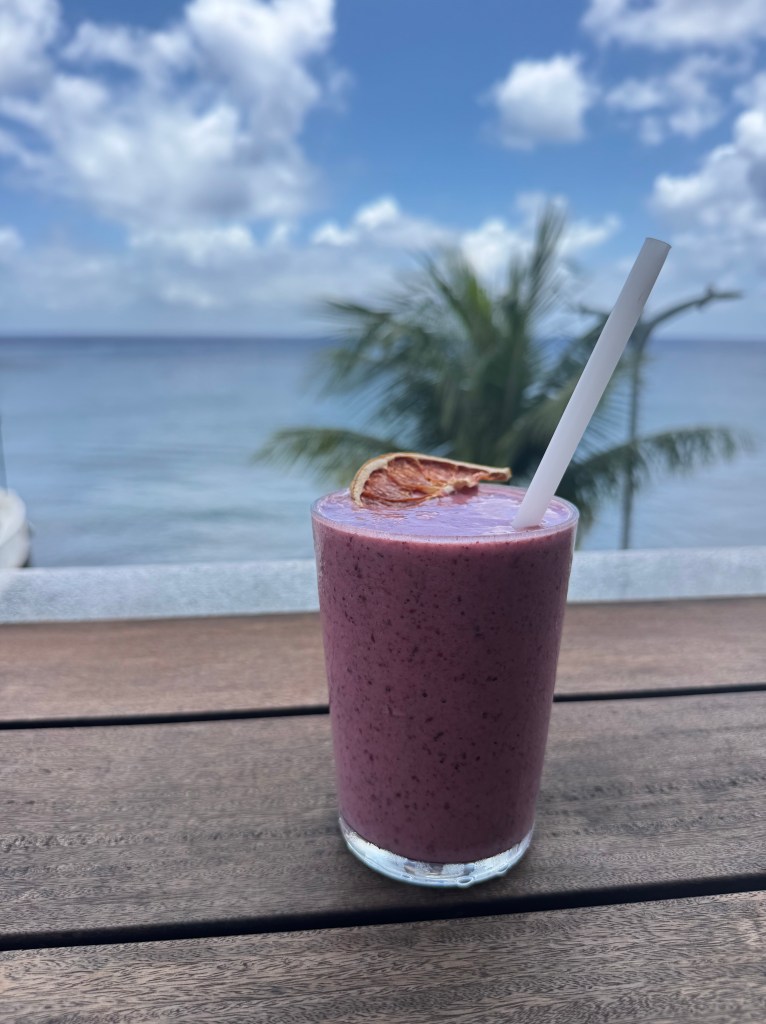 View of ocean with berry smoothie at Aqui + Ahora restaurant in Cozumel, Mexico