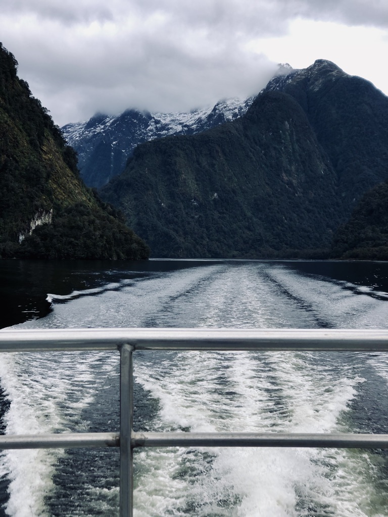 Boat tour water ripple with mountains at Doubtful Sound, New Zealand