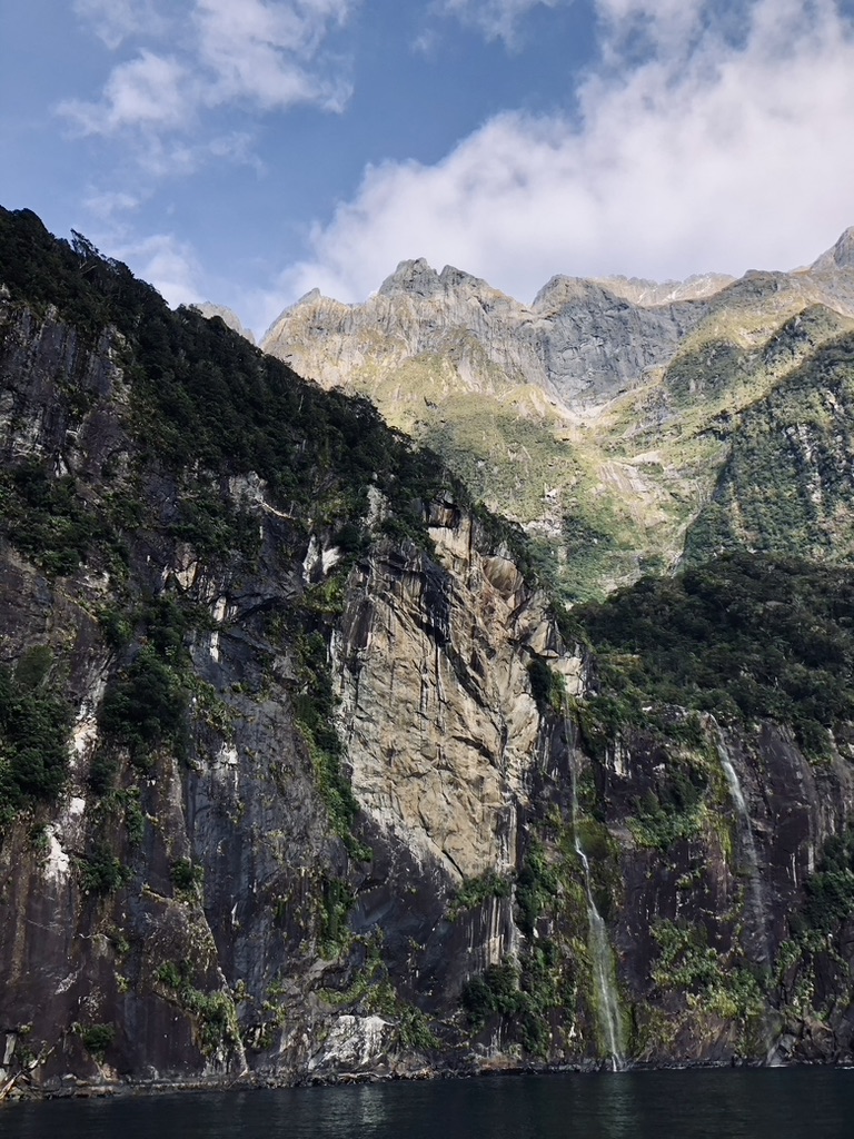 Cliffs and green mountains at Milford Sound, New Zealand