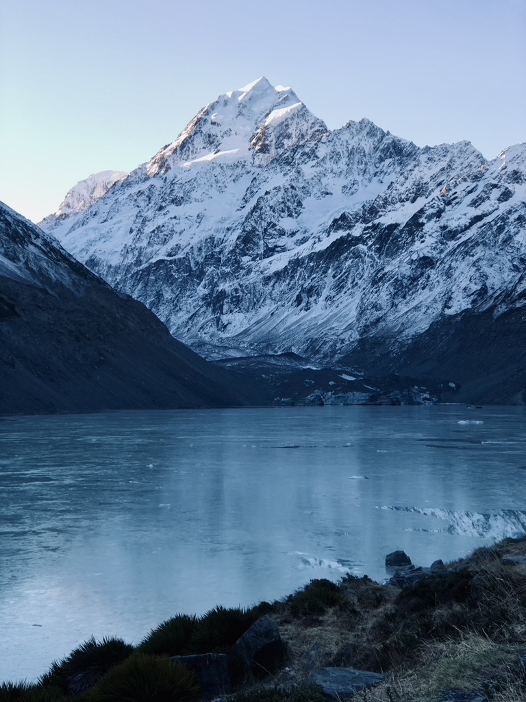 Glacier lake frozen over with Mt Cook on the Hooker Valley Track, New Zealand