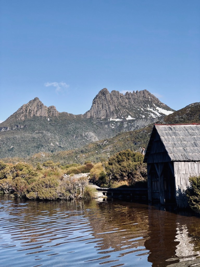 Cradle Mountain with lake and old wooden house in Tasmania, Australia