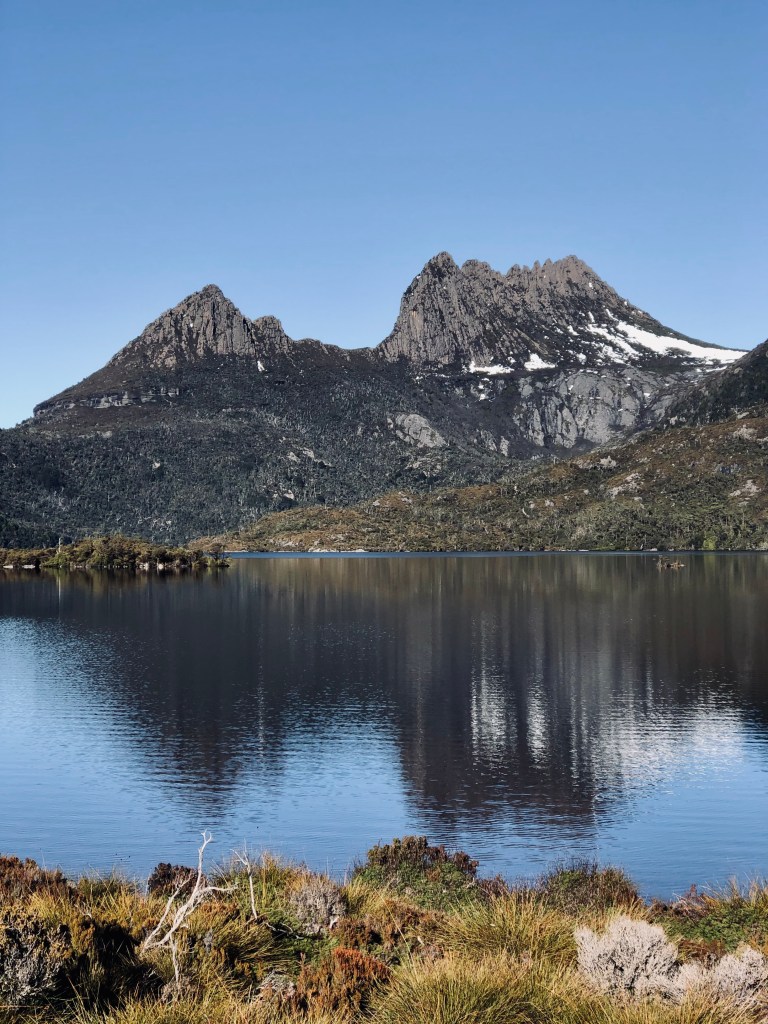 Cradle Mountain with reflection on lake and blue skies in Tasmania, Australia