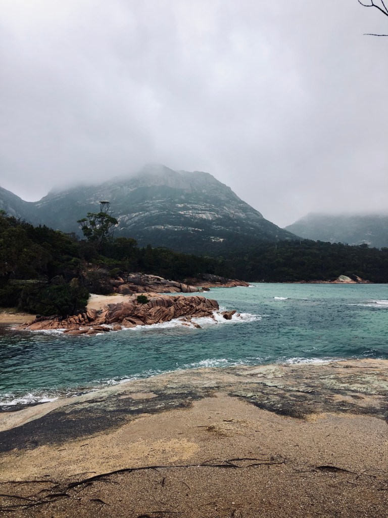 Misty day with view of ocean and mountains at Freycinet National Park, Tasmania