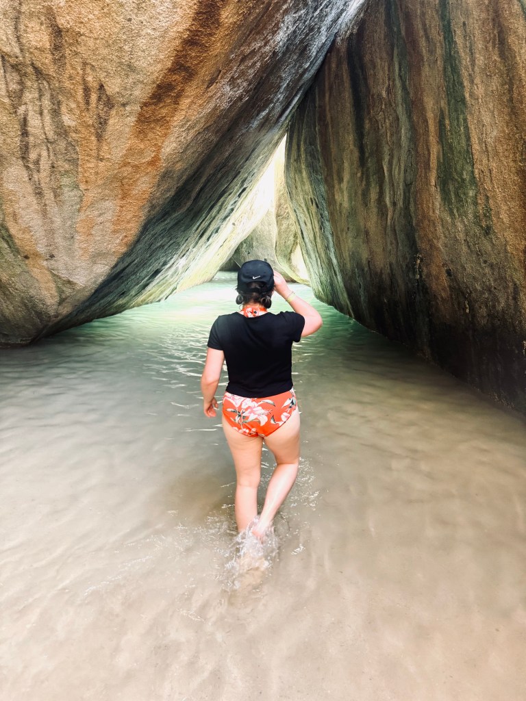 Girl walking into caves at The Baths Virgin Gorda