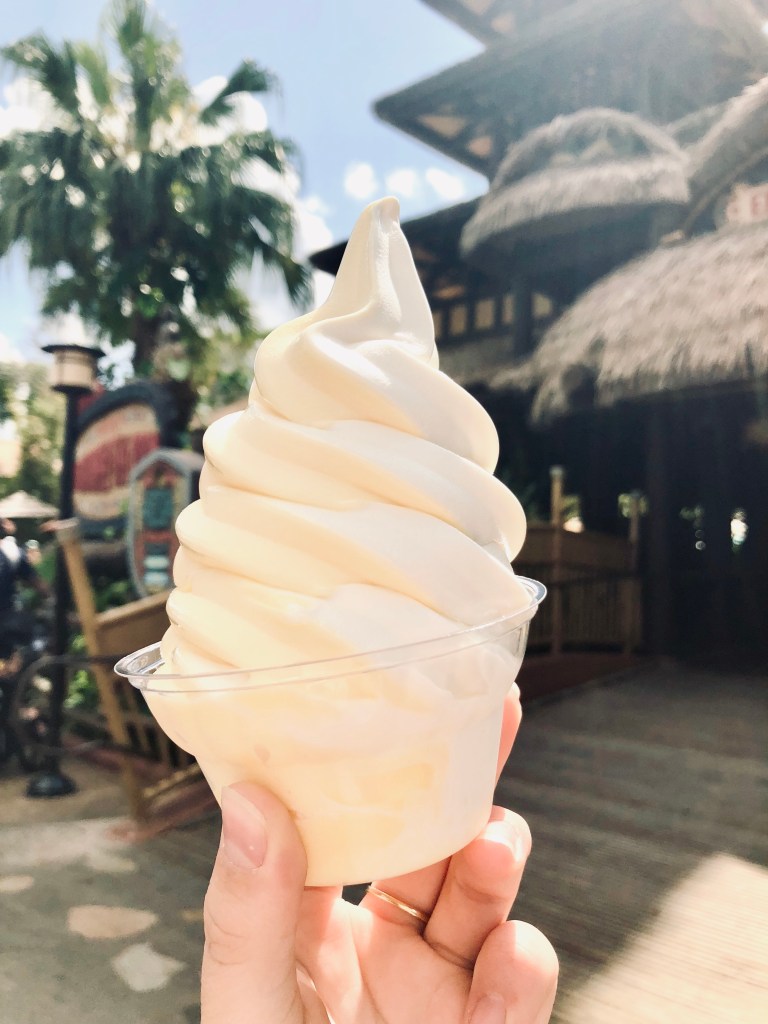Hand holding dole whip ice-cream in Adventureland at Magic Kingdom, Walt Disney World