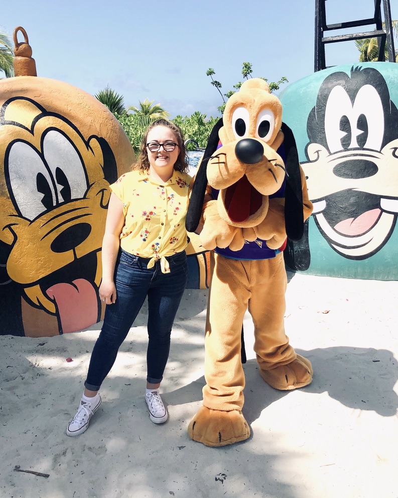 Disney Crew Member posing with Pluto character on Castaway Cay