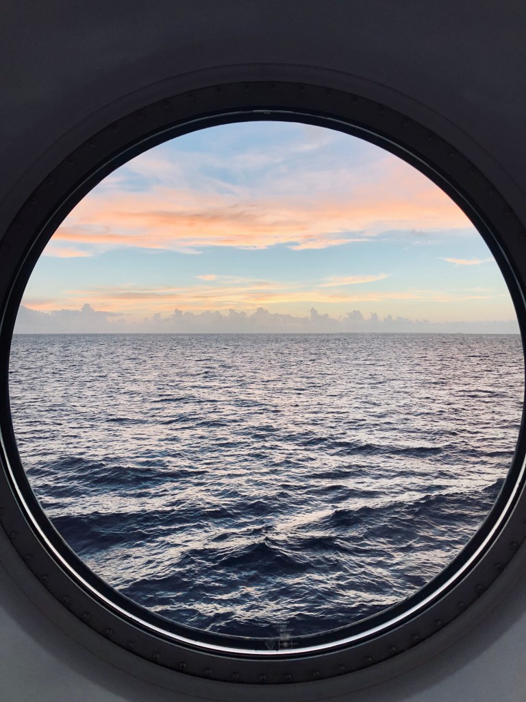 Port hole with beautiful sunset on a disney cruise ship