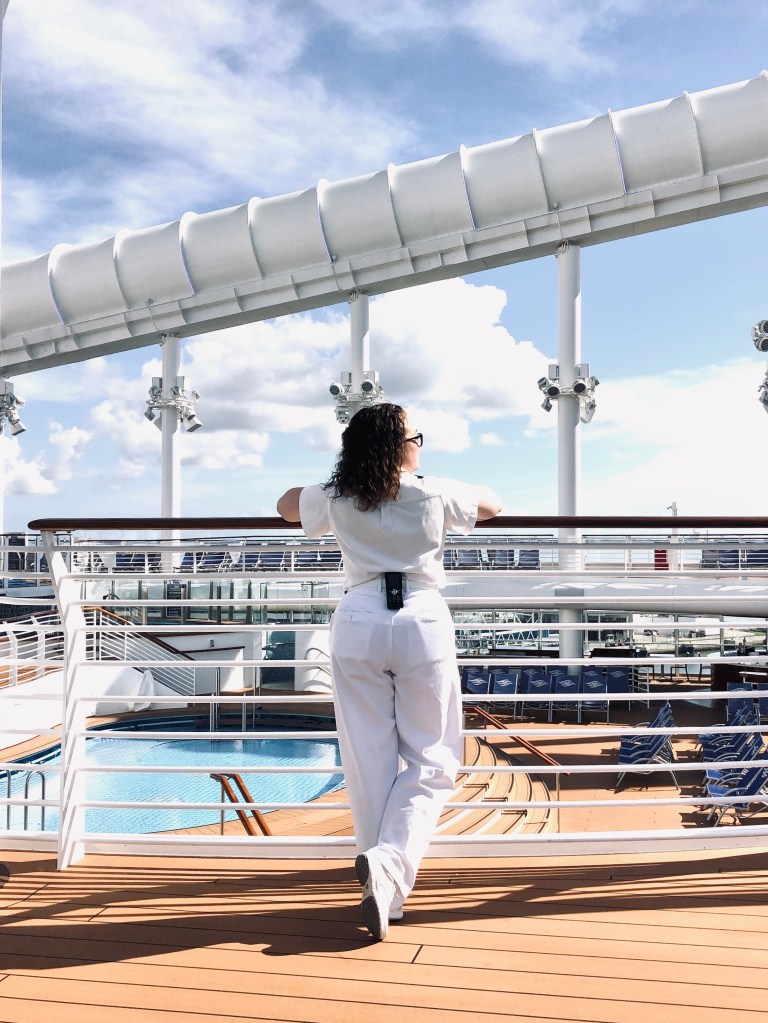 Disney Cruise Line officer looking out on pool deck on a disney cruise