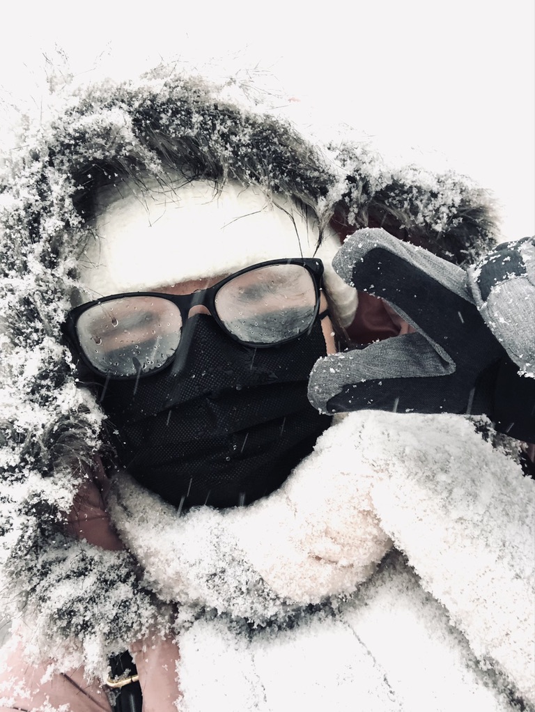Girl taking selfie in winter gear covered in snow in Hokkaido, Japan