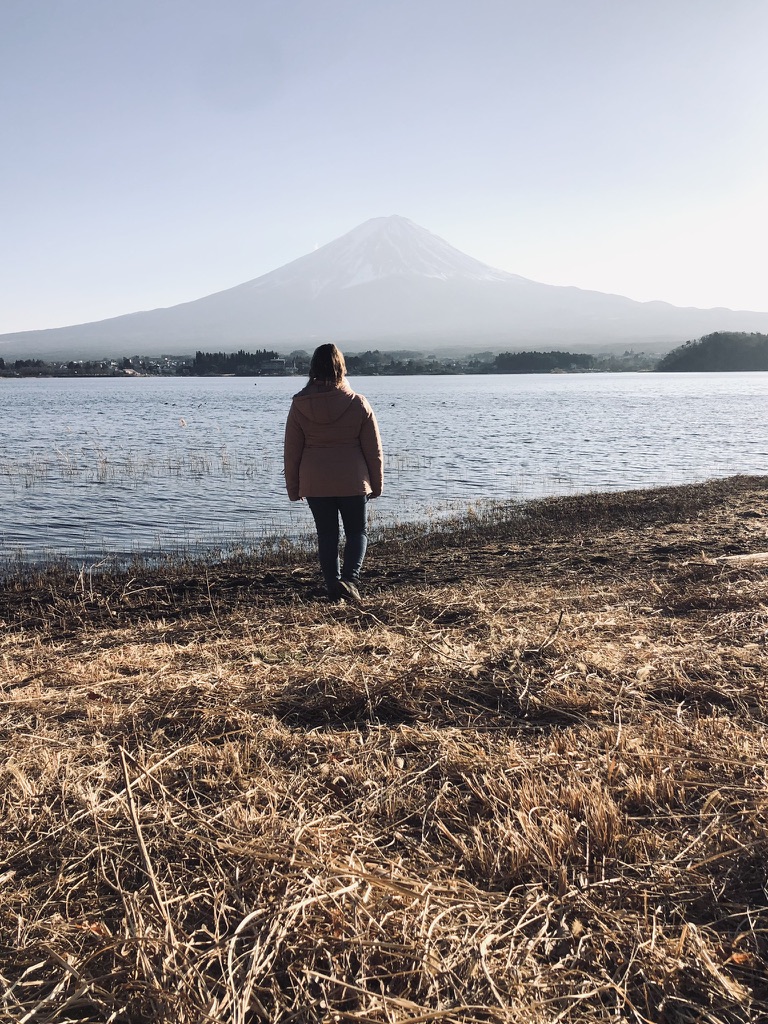 Girl walking towards view of Mt Fuji from kawaguchiko, Japan