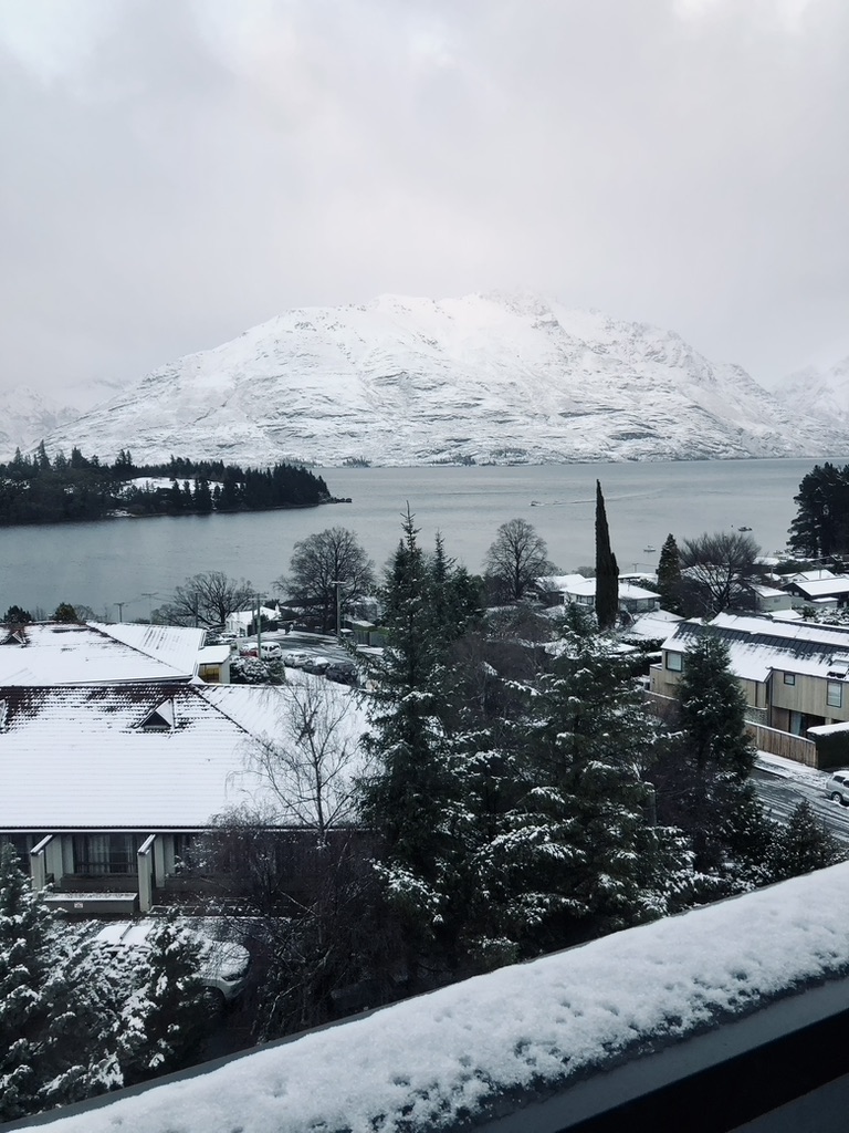 Snowy day with mountains and lake in Queenstown, New Zealand