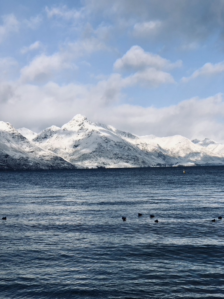 Snow capped mountains and lake in Queenstown, New Zealand
