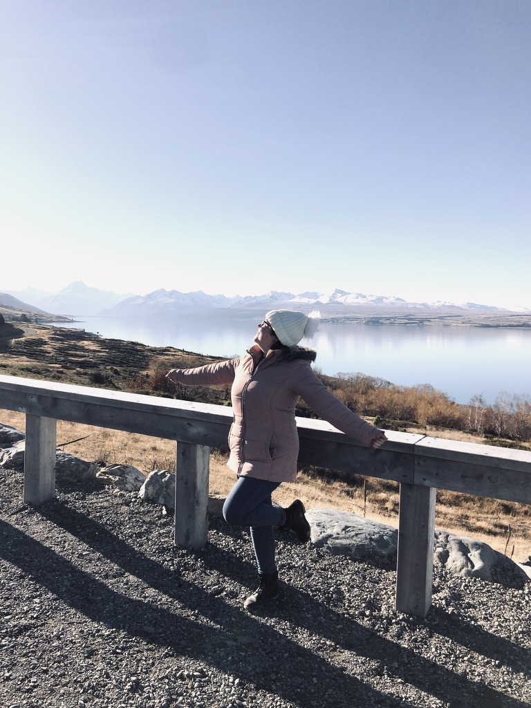 Girl looking out over lake on a road trip on New Zealand's South Island