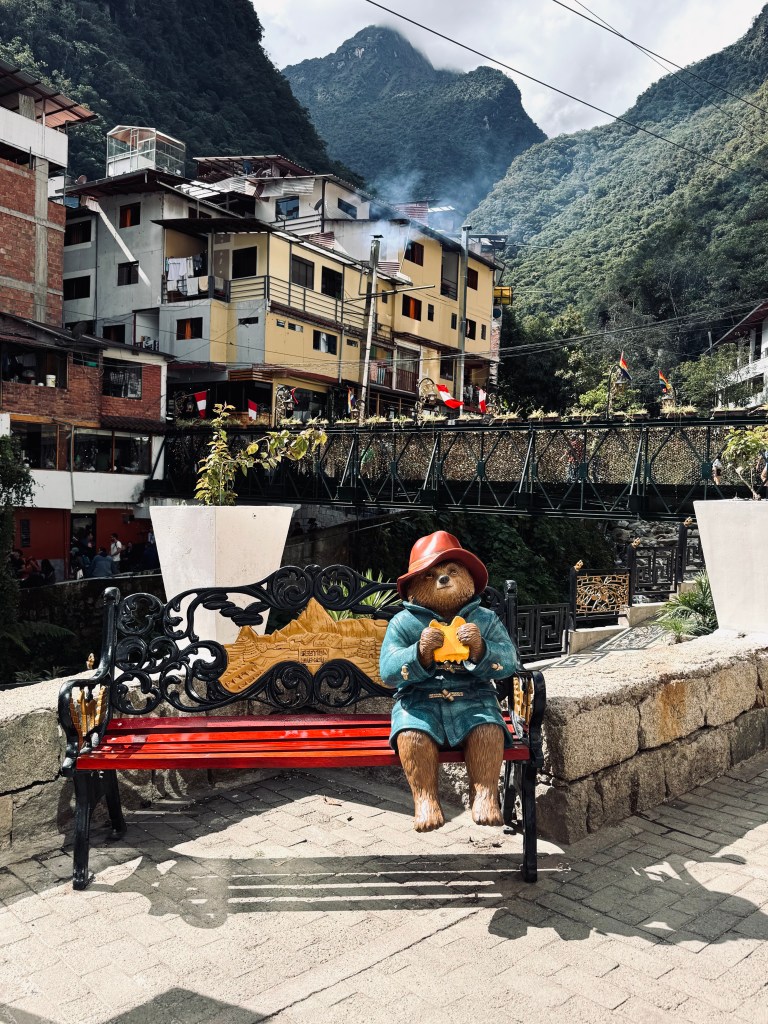 Paddington sitting on a bench statue in Aguas Calientes, Peru